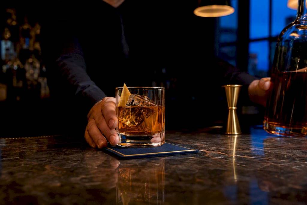 Bartender serving alcohol at a bar
